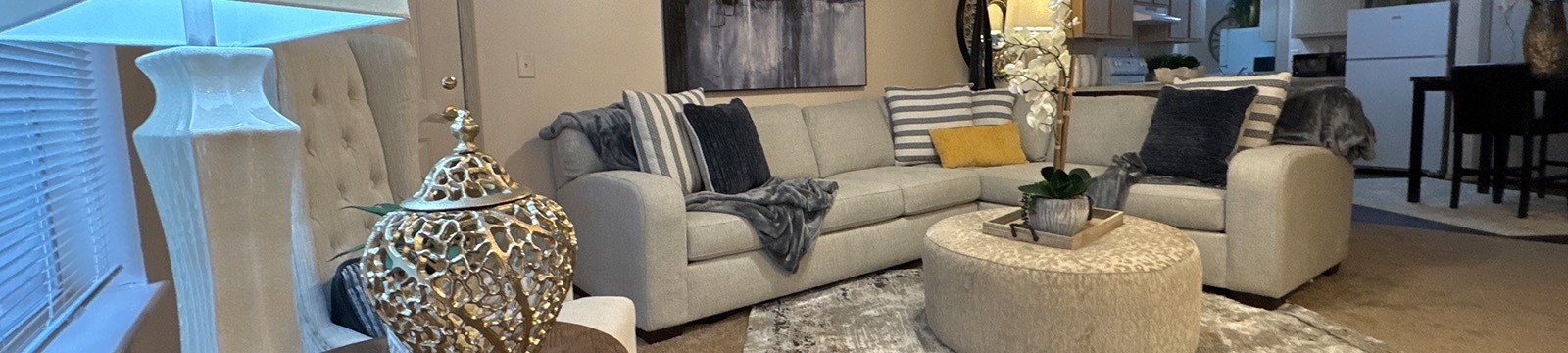A living room with a grey couch and a white coffee table.